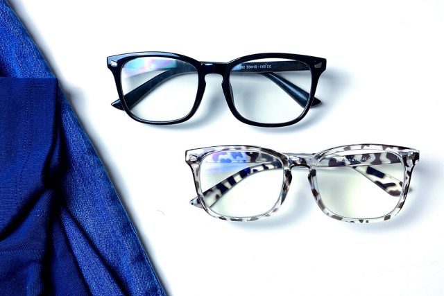 prescription eyeglasses on table by jeans